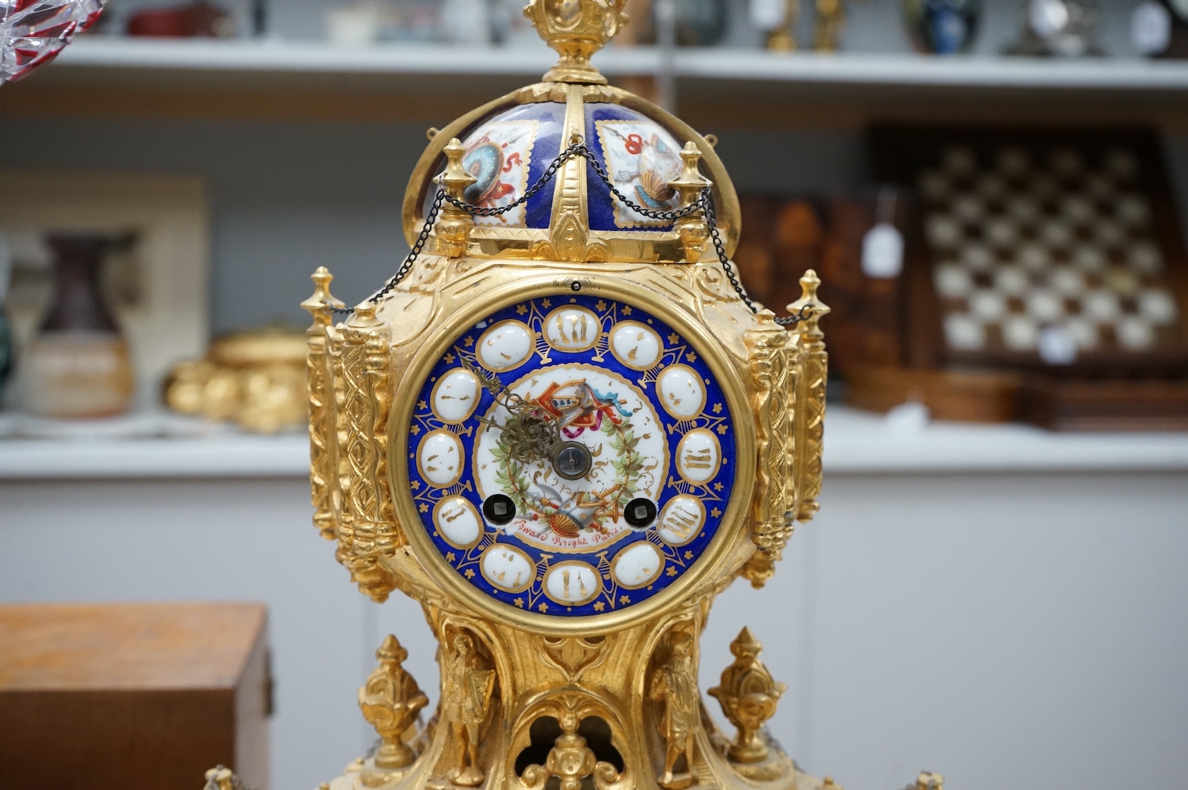 A late 19th century French ormolu mounted clock with enamelled dial and roundels depicting heraldic scenes, the dial inscribed Edward Bright, Paris, with pendulum, no key, 34cm high